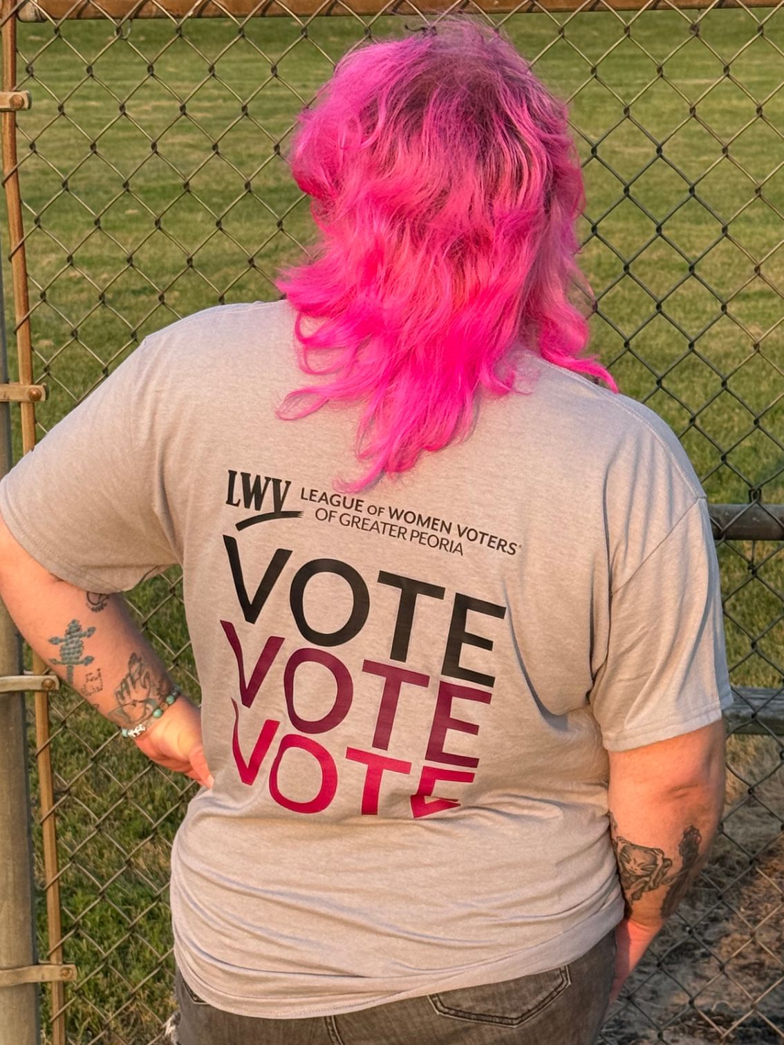 Person wearing shirt that states "VOTE VOTE VOTE"